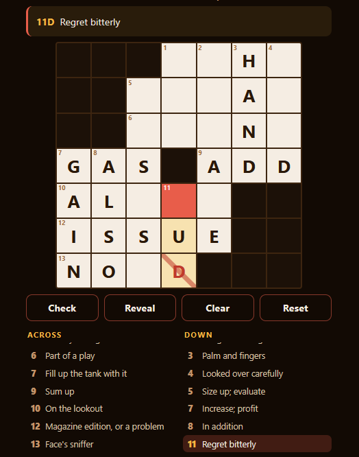 A partly solved 7x7 crossword with one square highlighted, the Check, Reveal, Clear and Reset buttons sitting below the grid, and the Across and Down clue lists beneath them.